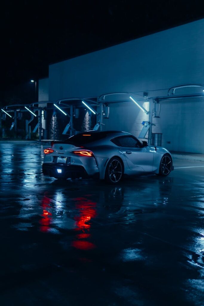 sleek-silver-sports-car-in-neon-lit-night-scene-28467940 sleek-silver-sports-car-in-neon-lit-night-scene-28467940